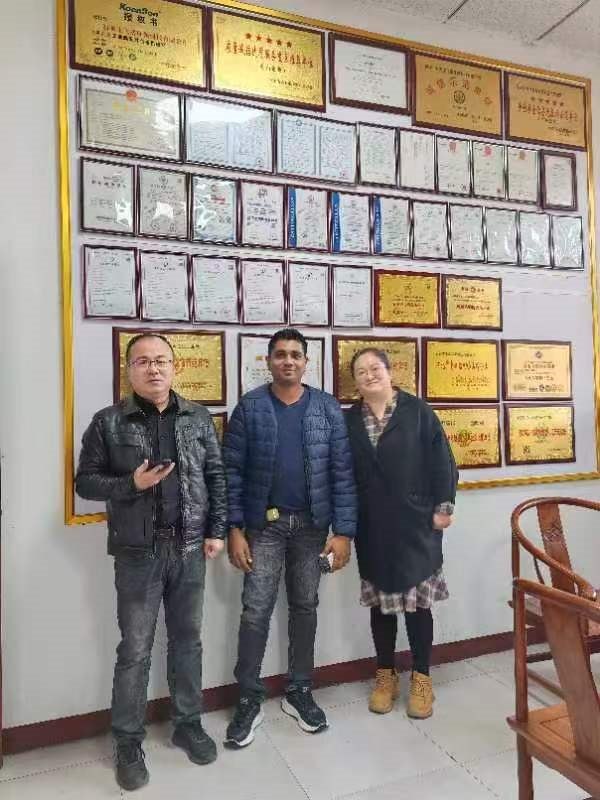 Group photo in front of our certificate wall